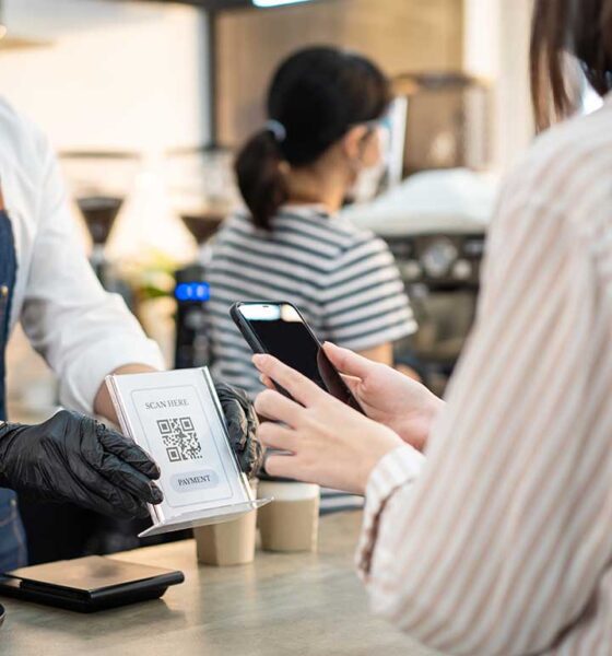 Pengguna uang elektronik membayar tagihan dengan metode non-tunai melalui aplikasi dompet digital